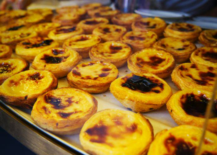 A display case filled with pastel de nata, Portugese egg tarts.